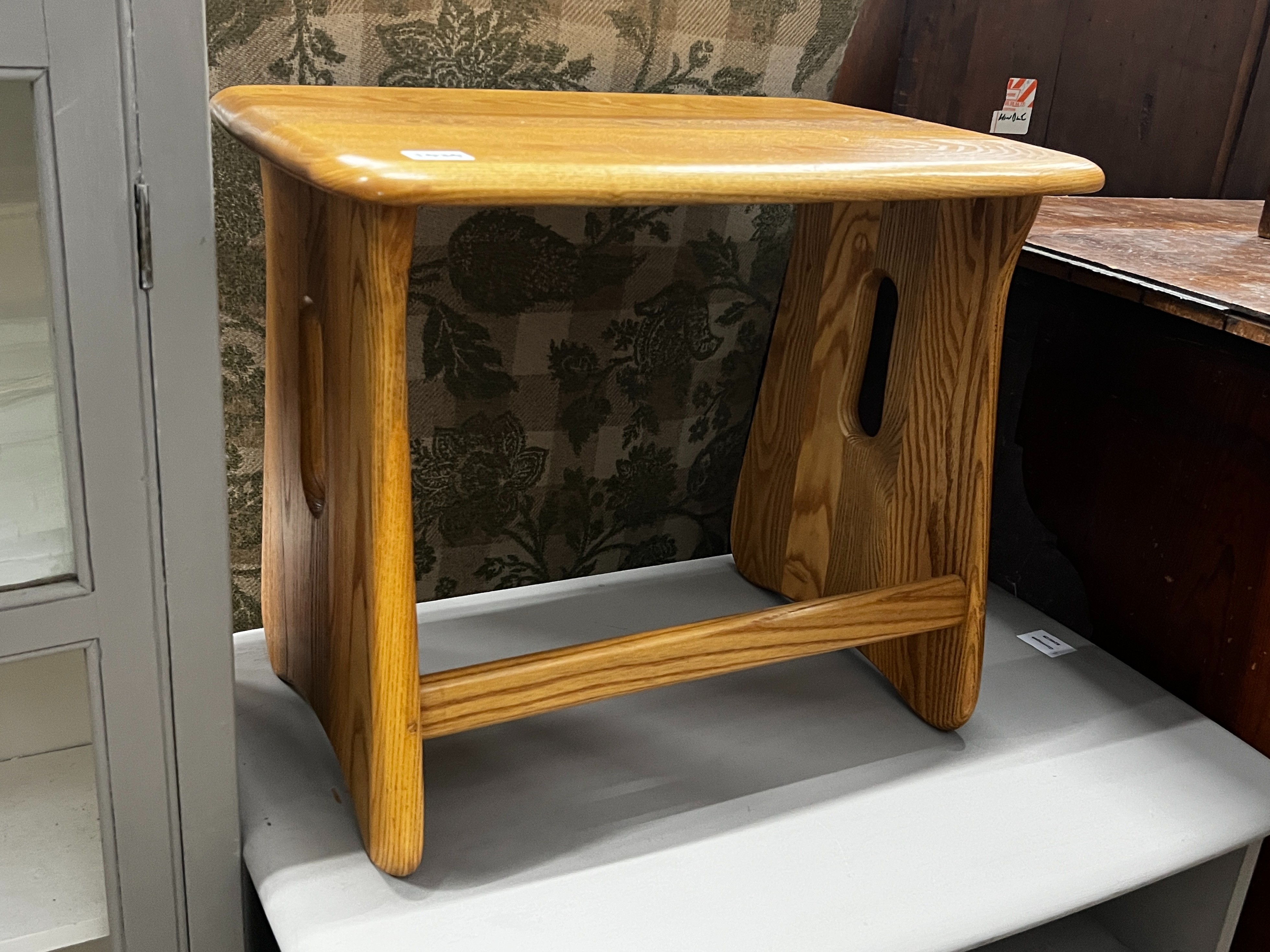 An Ercol rectangular elm occasional table, width 51cm, height 42cm together with an Ercol television stand, later painted